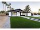 Landscaped front yard with artificial turf and walkway at 1743 W Butler Dr, Phoenix, AZ 85021