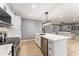 Modern kitchen boasting white cabinetry, quartz countertops, and stainless steel appliances at 1743 W Butler Dr, Phoenix, AZ 85021