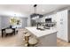 Modern kitchen with white cabinets, island, and dining area at 1743 W Butler Dr, Phoenix, AZ 85021