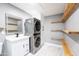 Laundry room with stacked washer and dryer, and shelves at 1743 W Butler Dr, Phoenix, AZ 85021