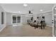 A large, naturally lit living room with new floors, modern furnishings, and view to pool through sliding glass door at 1743 W Butler Dr, Phoenix, AZ 85021