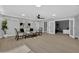 A large, naturally lit living room with new floors, modern furnishings, and view to another room through open French doors at 1743 W Butler Dr, Phoenix, AZ 85021