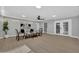 A large, naturally lit living room with new floors, modern furnishings, and view to another room through French doors at 1743 W Butler Dr, Phoenix, AZ 85021