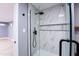 Modern shower with marble tile and glass enclosure at 1743 W Butler Dr, Phoenix, AZ 85021