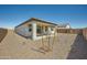 Private backyard features covered patio, low-maintenance landscaping, and block fence at 17603 W Superior Ave, Goodyear, AZ 85338