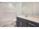 Modern bathroom with sleek vanity, white countertop, and shower/tub combo at 17603 W Superior Ave, Goodyear, AZ 85338