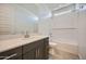 Bathroom with modern vanity, white countertop, and shower/tub combo for versatile use at 17603 W Superior Ave, Goodyear, AZ 85338
