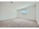 Bedroom featuring plush carpeting, a bright window, and neutral color palette at 17603 W Superior Ave, Goodyear, AZ 85338