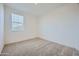 Bright bedroom featuring plush carpeting, white walls and a window allowing for natural light at 17603 W Superior Ave, Goodyear, AZ 85338