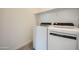 Well-lit laundry room with modern washer and dryer, plus handy shelving space at 17603 W Superior Ave, Goodyear, AZ 85338