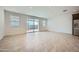 Bright living room with tile floors, recessed lights, and sliding glass door to backyard at 17603 W Superior Ave, Goodyear, AZ 85338