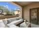 Relaxing covered balcony with neutral toned furniture, textured throw pillows, and outdoor view at 20100 N 78Th Pl # 1040, Scottsdale, AZ 85255