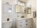 Elegant bathroom with modern lighting, marble countertop, vanity, and decorative mirror and artwork at 20100 N 78Th Pl # 1040, Scottsdale, AZ 85255