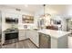 Bright kitchen with stainless steel appliances, white cabinets, countertops and open shelves for easy access at 20100 N 78Th Pl # 1040, Scottsdale, AZ 85255