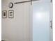 Modern interior wall features a frosted glass sliding door with metallic accent hardware and framed pictures at 20100 N 78Th Pl # 1040, Scottsdale, AZ 85255
