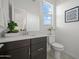 Modern bathroom with dark cabinets, white countertop, vanity, commode, and decorative accessories at 2027 W Sleepy Ranch Rd, Phoenix, AZ 85085