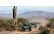 Group of off-road vehicles enjoying a desert adventure against a mountain backdrop at 2027 W Sleepy Ranch Rd, Phoenix, AZ 85085