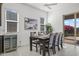 Elegant dining room features a table set for six, a wine fridge, and patio access at 2027 W Sleepy Ranch Rd, Phoenix, AZ 85085