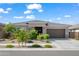 Attractive single-story home featuring desert landscaping, a paved driveway, and a two-car garage at 2027 W Sleepy Ranch Rd, Phoenix, AZ 85085