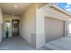 Exterior view of the front entry and garage of a modern home with neutral tones at 2027 W Sleepy Ranch Rd, Phoenix, AZ 85085