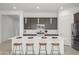 Modern kitchen island with seating, stainless steel appliances, and elegant pendant lighting at 2027 W Sleepy Ranch Rd, Phoenix, AZ 85085
