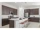 Stylish kitchen featuring a large island with seating, stainless steel appliances, and pendant lighting at 2027 W Sleepy Ranch Rd, Phoenix, AZ 85085
