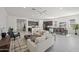Spacious open-concept living room with modern furnishings, adjacent to a kitchen and dining area at 2027 W Sleepy Ranch Rd, Phoenix, AZ 85085