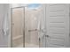 Walk-in shower featuring glass door, marble tile, bench seating, and shower bar at 2027 W Sleepy Ranch Rd, Phoenix, AZ 85085