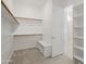 Spacious walk-in closet with wood shelving and a bench with shoe storage at 2027 W Sleepy Ranch Rd, Phoenix, AZ 85085