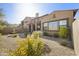 Private desert-landscaped backyard with water feature and covered patio at 20750 N 87Th St # 1009, Scottsdale, AZ 85255