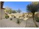 Desert-landscaped backyard features a decorative fountain and a paved walkway at 20750 N 87Th St # 1009, Scottsdale, AZ 85255