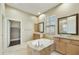 Bathroom featuring a large tub, dual sinks, and tiled floor at 20750 N 87Th St # 1009, Scottsdale, AZ 85255