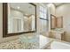 Bright bathroom featuring a vessel sink with granite countertop and decorative mirror at 20750 N 87Th St # 1009, Scottsdale, AZ 85255