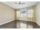 Spacious bedroom with hardwood floors, ceiling fan, and a large window at 20750 N 87Th St # 1009, Scottsdale, AZ 85255
