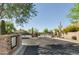 Gated entrance to a community with desert landscaping and well-maintained streets at 20750 N 87Th St # 1009, Scottsdale, AZ 85255