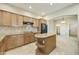 Well-lit kitchen with granite countertops, center island and black appliances at 20750 N 87Th St # 1009, Scottsdale, AZ 85255