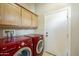 Convenient laundry room with side-by-side washer and dryer beneath ample cabinetry at 20750 N 87Th St # 1009, Scottsdale, AZ 85255