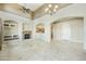 Inviting living room with fireplace, travertine flooring, and open access to kitchen and dining area at 20750 N 87Th St # 1009, Scottsdale, AZ 85255