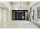 Elegant living room with travertine floors, a modern chandelier, and access to the patio at 20750 N 87Th St # 1009, Scottsdale, AZ 85255