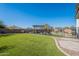 Landscaped backyard with pergola, artificial turf and pool at 22633 E Domingo Rd, Queen Creek, AZ 85142