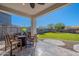 Covered patio with seating area and view of grassy backyard at 22633 E Domingo Rd, Queen Creek, AZ 85142