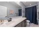 Clean bathroom with a white vanity and dark blue shower curtain at 22633 E Domingo Rd, Queen Creek, AZ 85142