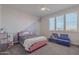 Cozy bedroom with pink bed frame and window seating at 22633 E Domingo Rd, Queen Creek, AZ 85142
