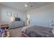 Charming bedroom with gray bed, dresser, and TV at 22633 E Domingo Rd, Queen Creek, AZ 85142