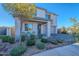 Modern two-story home with light-colored stone and landscaping at 22633 E Domingo Rd, Queen Creek, AZ 85142