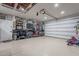 Well-organized garage with overhead storage and work bench at 22633 E Domingo Rd, Queen Creek, AZ 85142