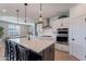 Modern kitchen with white cabinets, island, and stainless steel appliances at 22633 E Domingo Rd, Queen Creek, AZ 85142