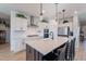 Modern kitchen with white cabinets, quartz countertops, and stainless steel appliances at 22633 E Domingo Rd, Queen Creek, AZ 85142