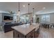 Open concept kitchen with island and view of living room and backyard at 22633 E Domingo Rd, Queen Creek, AZ 85142