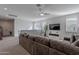 Spacious loft living area features a large sectional sofa and flat-screen TV at 22633 E Domingo Rd, Queen Creek, AZ 85142